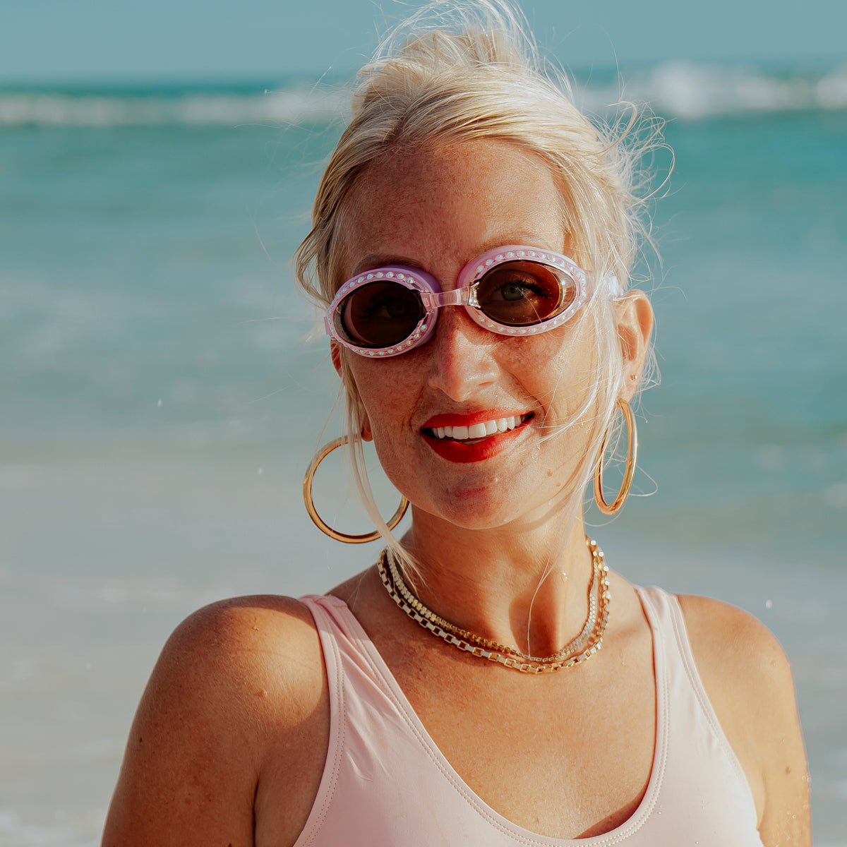 adult woman wearing tranquility swim goggles showing tinted lens and rhinestone detail