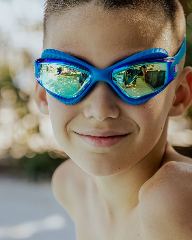 explore the pool kids swim goggles in freshwater lifestyle image of boy wearing freshwater swim goggles poolside