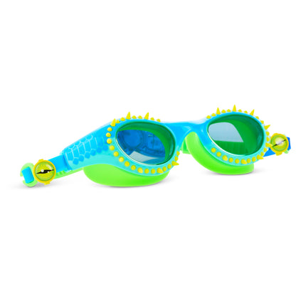 angled view of Jurassic Dive Kids Swim Goggles in stego splash showing silicone spikes, blue lenses, a reptilian printed frame and eyeball strap sliders