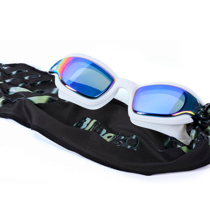 styled shot of Softline Swim Goggles in puff showing textured frame, mirrored lens, and soft strap