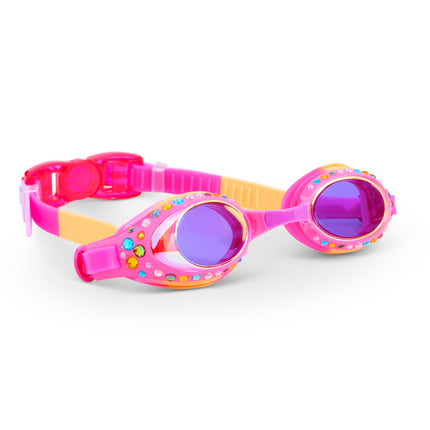 angled view of glimmering gemstones kids' swim goggles in tropical tanzanite showing rhinestones and gems on a bright pink swim goggle frame