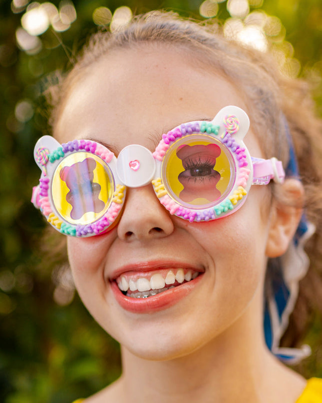 girl smiling wearing gummy bear kids' swim goggles in lollipop showing 3D gummy bears and a gummy bear screen print