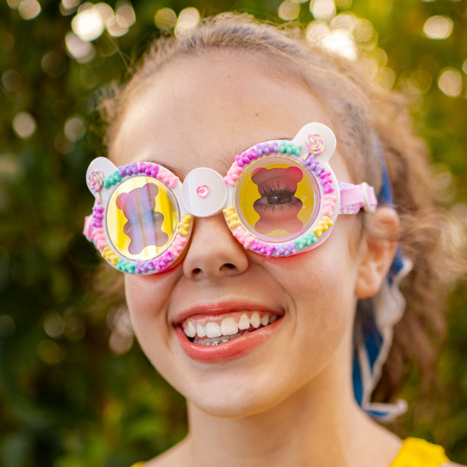 girl smiling wearing gummy bear kids' swim goggles in lollipop showing 3D gummy bears and a gummy bear screen print