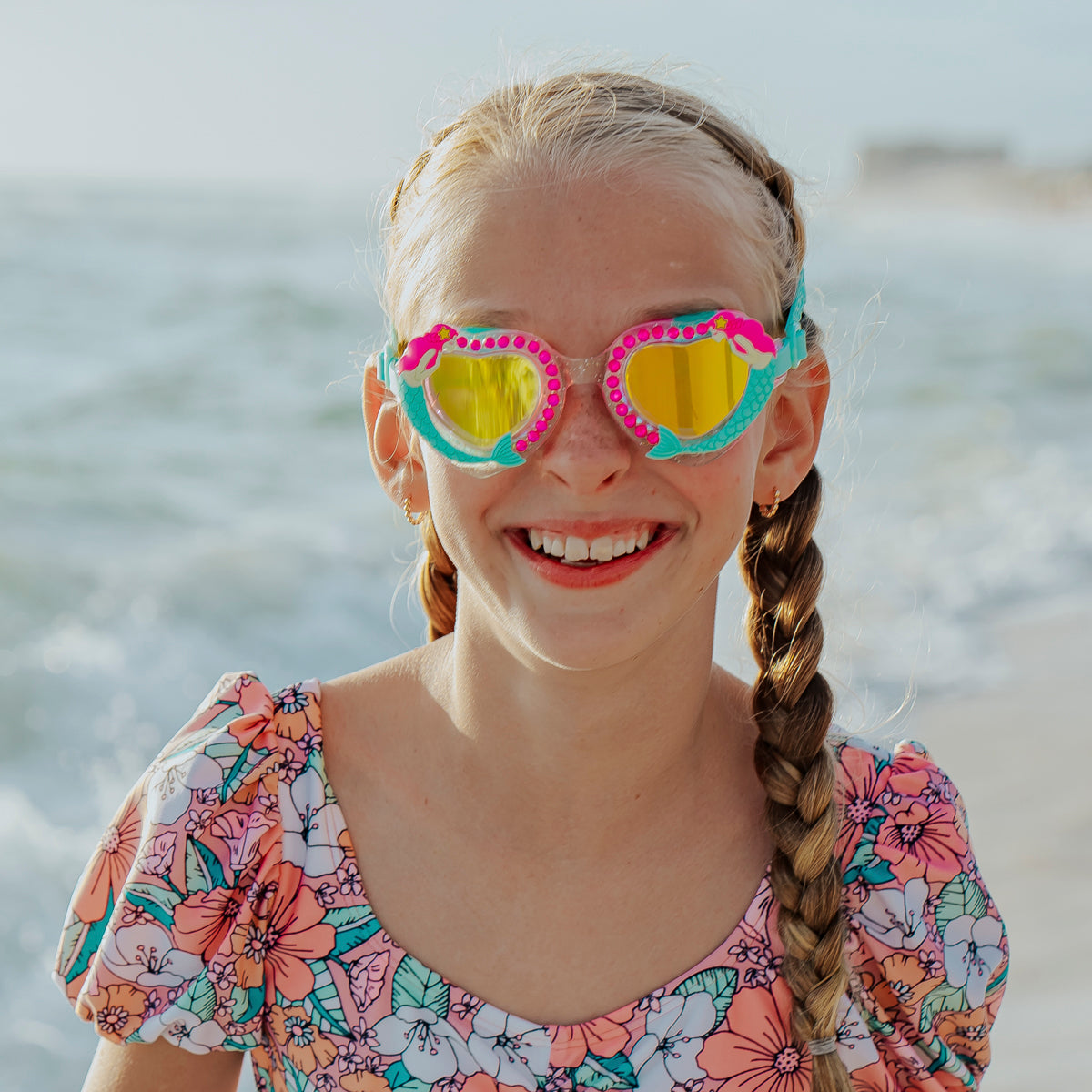 girl at beach wearing mystical mermaid kids' swim goggles showing 3d mermaid detail and rhinestones