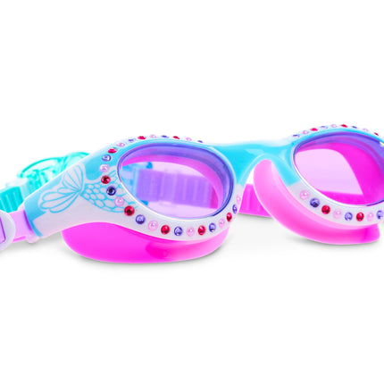 angled view of neptune's pearl kids swim goggles in seafoam siren showing mermaid tail illustration on frame and rhinestones