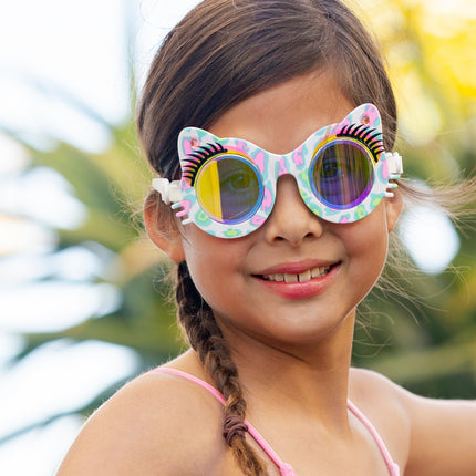 girl smiling wearing savvy cat kids' cat-shaped swim goggles showing cheetah printed frame, faux eyelashes and rhinestones