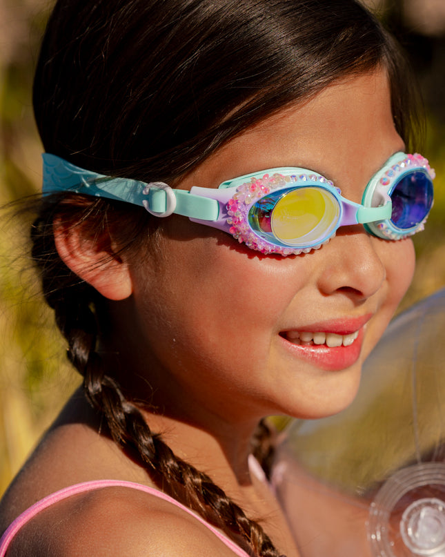 girl smiling poolside wearing seaquin kids swim goggles in seabreeze classic shaped swim goggles showing details of rhinestones and crushed rhinestone details