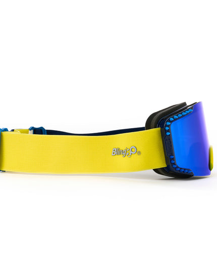 side product shot of prism peak kids ski goggles in blue bird which features a blue mirrored lens with blue silicone spikes and a yellow nose piece with yellow strap