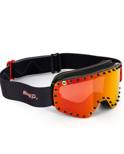 top angle of prism peak kids' ski goggles featuring a red orange mirrored lens with black spikes and a monster eye decal with a black strap and red buckle