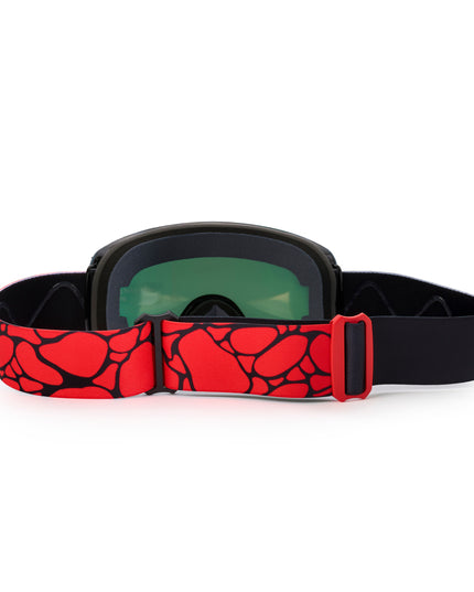 back angle of prism peak kids' ski goggles featuring a red orange mirrored lens with black spikes and a monster eye decal with a black and red patterned strap and red buckle
