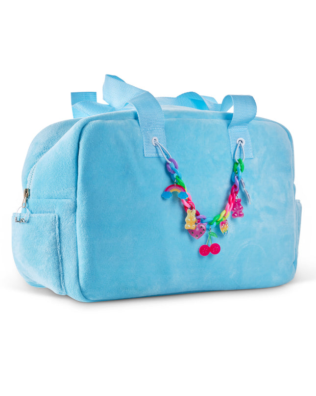 angled view of Blue Crush Velour Tote showing rainbow chain link with charms. charms are rainbow charm, gummy bear charm, cherry charm, heart charm, and sunglass charm on rainbow chain link