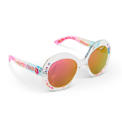 angled view of glass beach kids sunglasses in sprinkle sunrise showing reflective lens, clear large round frame with 3D gumballs in the arm of the sunglass
