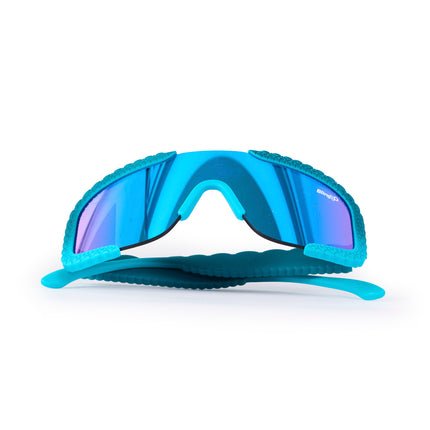 folded up product shot of gulf shore kids' sunglasses in siesta sea featuring a vibrant blue color and crocodile-inspired texture and shield reflective lens