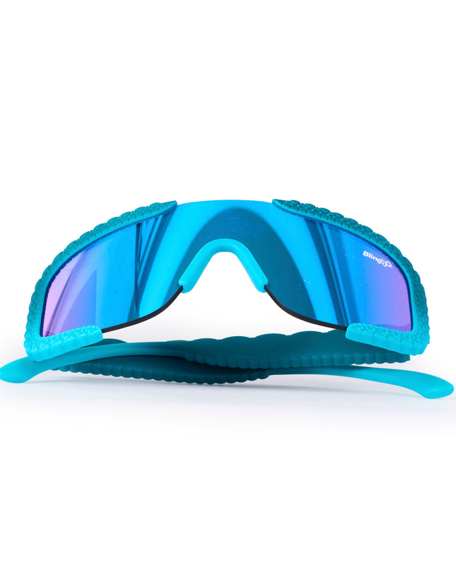 folded up product shot of gulf shore kids' sunglasses in siesta sea featuring a vibrant blue color and crocodile-inspired texture and shield reflective lens