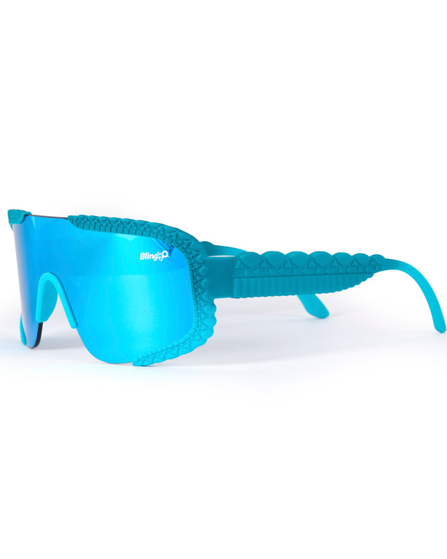 angled product shot of gulf shore kids' sunglasses in siesta sea featuring a vibrant blue color and crocodile-inspired texture