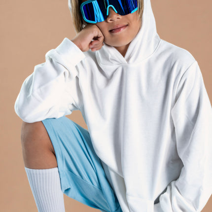 kid smiling and posing wearing gulf shore kids' sunglasses in the color siesta sea