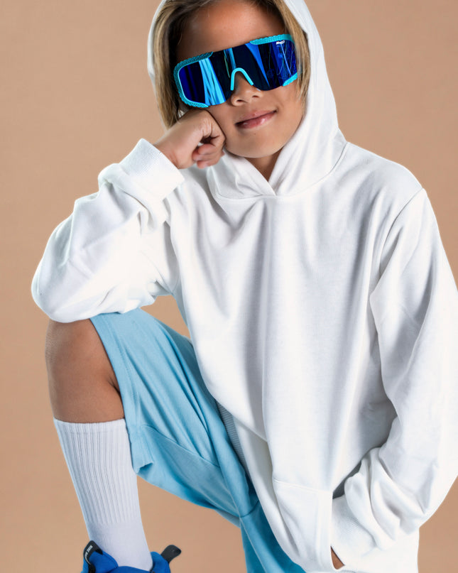 kid smiling and posing wearing gulf shore kids' sunglasses in the color siesta sea