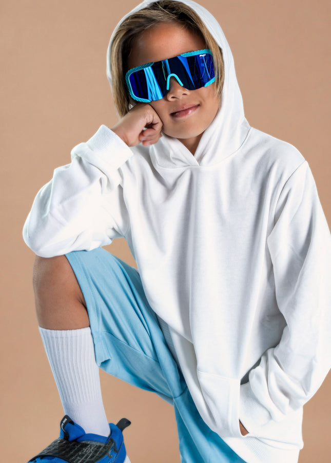 kid smiling and posing wearing gulf shore kids' sunglasses in the color siesta sea