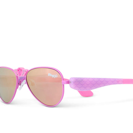 angled view of hampton beach sunglasses in bright bubblegum showing an aviator frame with mirrored lens and a crown nose piece and mermaid tail themed arms of sunglasses