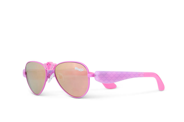 angled view of hampton beach sunglasses in bright bubblegum showing an aviator frame with mirrored lens and a crown nose piece and mermaid tail themed arms of sunglasses