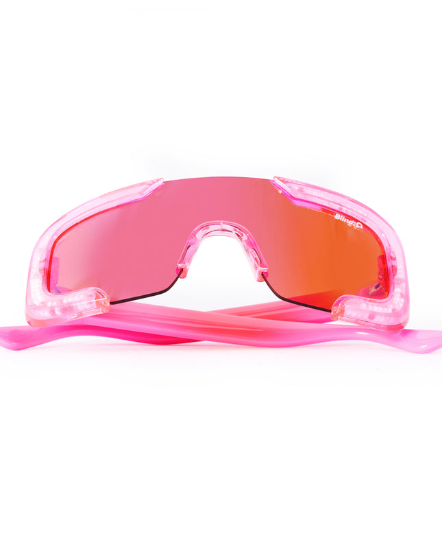 folded product shot of pink sand kids' sunglasses in color sprinkle pink featuring shield frame with 3-d sprinkles in the frame, heart insignia and all pink frame and lens