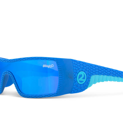 angled view of sand harbor kids' sunglasses in sky blue stegosaur showing a sleek frame and dino textured arm of sunglass