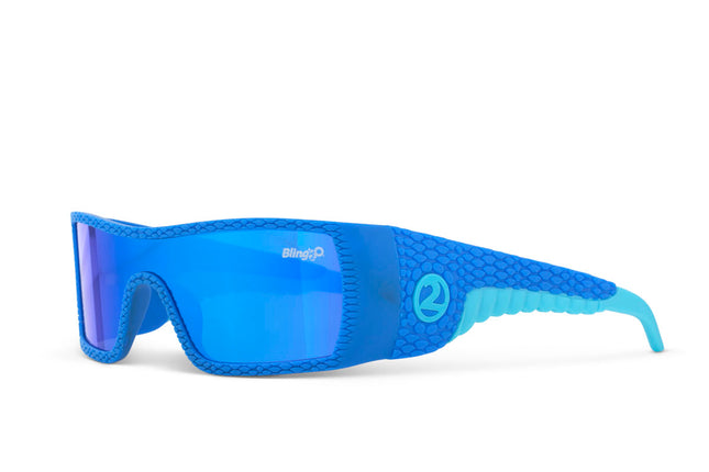 angled view of sand harbor kids' sunglasses in sky blue stegosaur showing a sleek frame and dino textured arm of sunglass