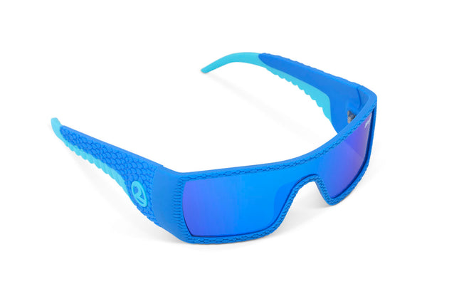 angled view of sand harbor kids' sunglasses in sky blue stegosaur showing a sleek frame and dino textured arm of sunglass