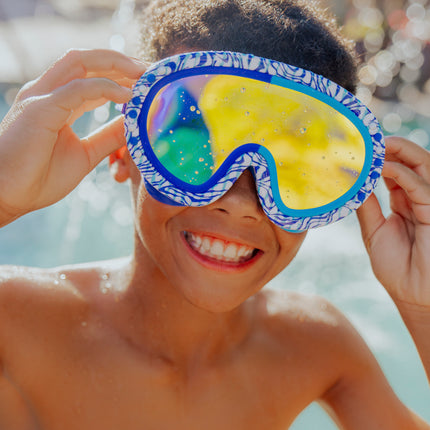 lifestyle image of boy smiling wearing dino dash swim mask showing reflective lens 