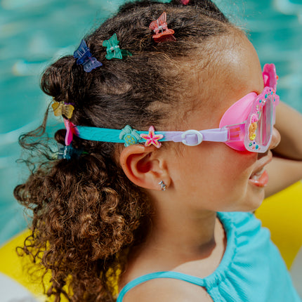 angled lifestyle image of girl in pool in enchanted shoreline showing turtle and starfish silicone strap sliders