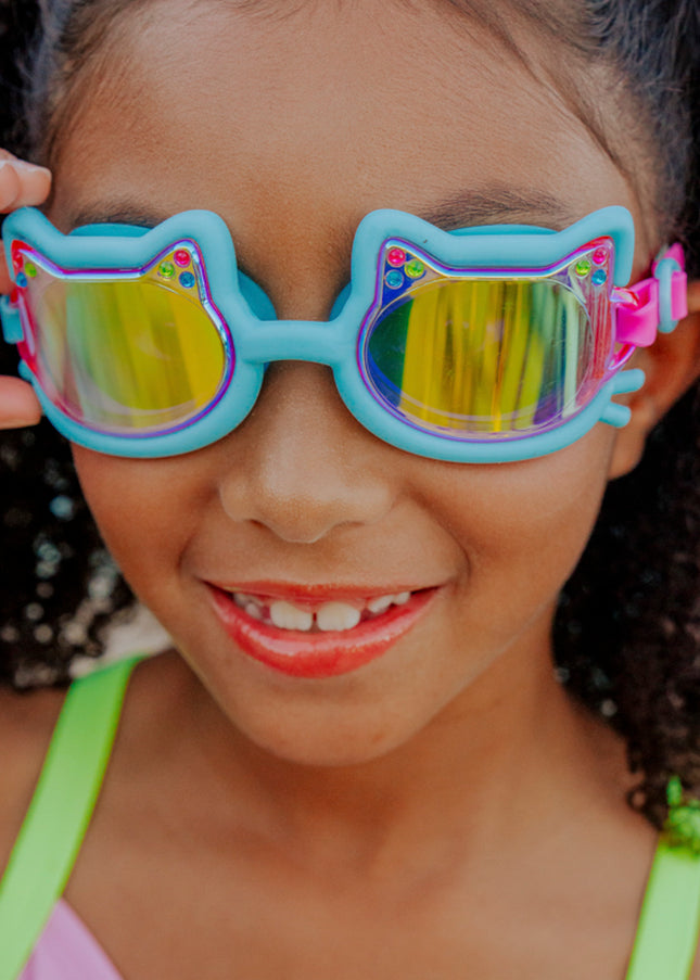 lifestyle of girl smiling wearing flexi feline blue all silicone swim goggles 