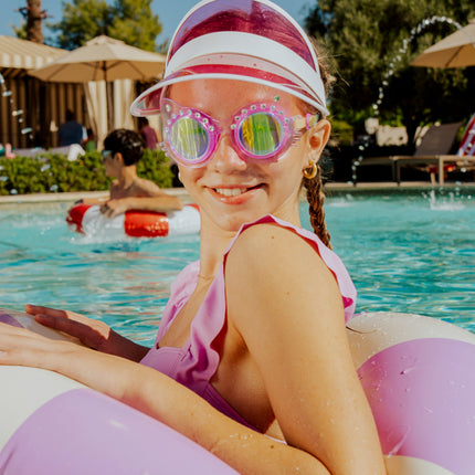 lifestyle of girl in pool wearing frosted feline kids swim goggles in purrfect purple