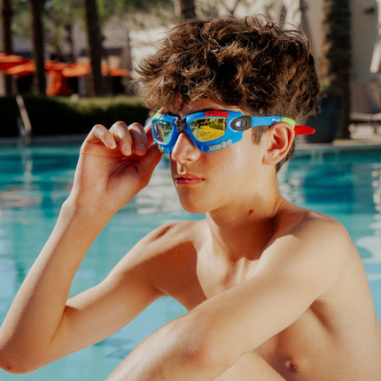 lifestyle of model poolside wearing gamer kids swim goggles in console cobalt blue showing gaming details on frame