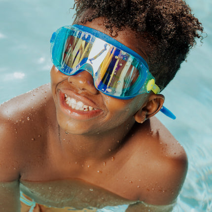 lifestyle of boy swimming wearing hologram kids swim goggles in polar stream showing frameless lens and blue gasket