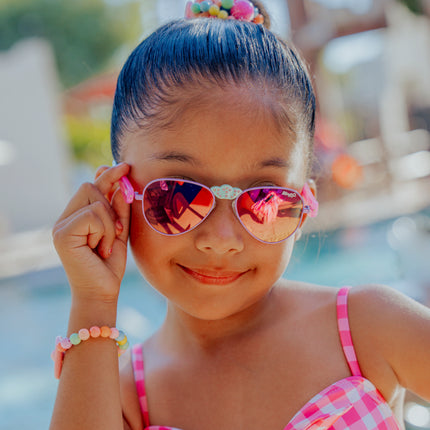 lifestyle of girl smiling posing hampton kids sunglasses in suntan turq 