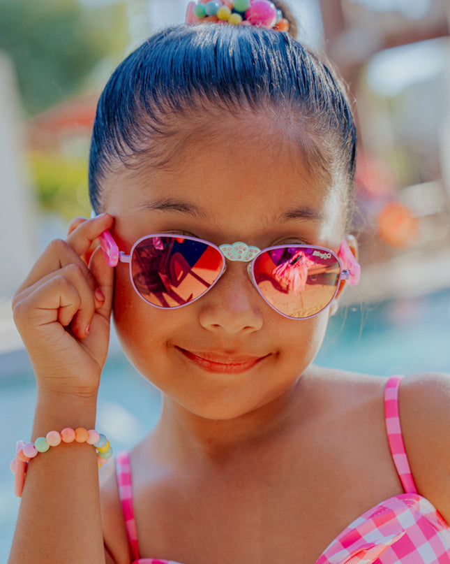 lifestyle of girl smiling posing hampton kids sunglasses in suntan turq 