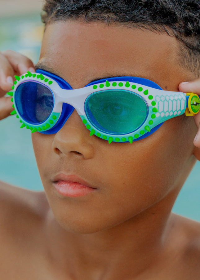 lifestyle of kid wearing jurassic dive in seafoam spike showing silicone spike and reptilian printed frame detail with eye ball slider