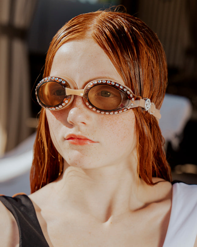 teen girl wearing seek tranquility swim goggles showing tortoise shell frame and rhinestones 