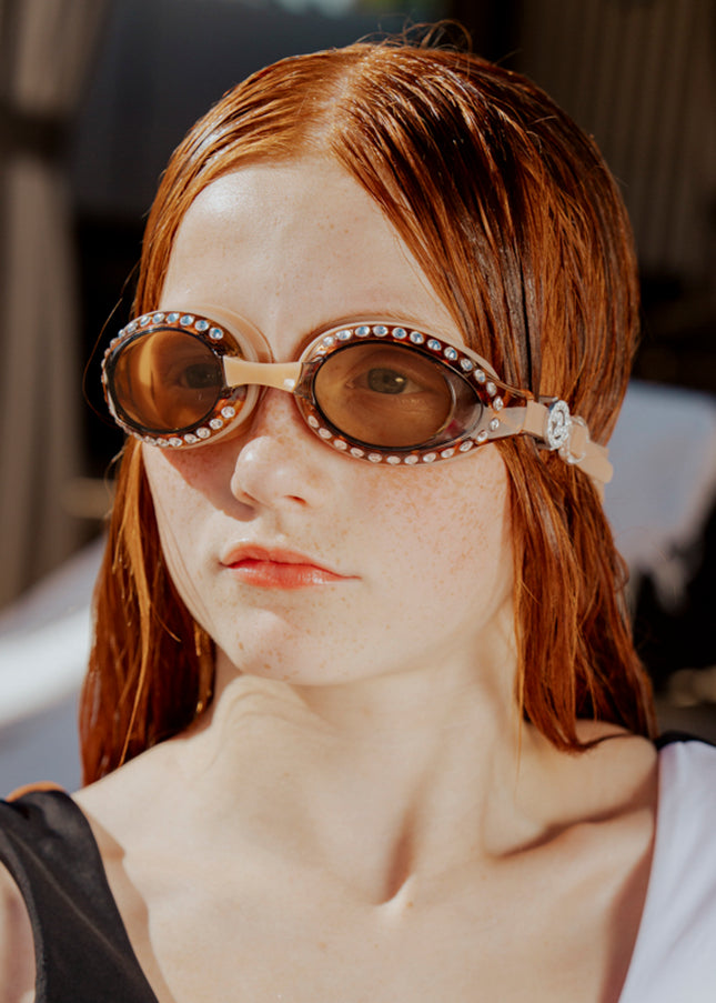 teen girl wearing seek tranquility swim goggles showing tortoise shell frame and rhinestones 