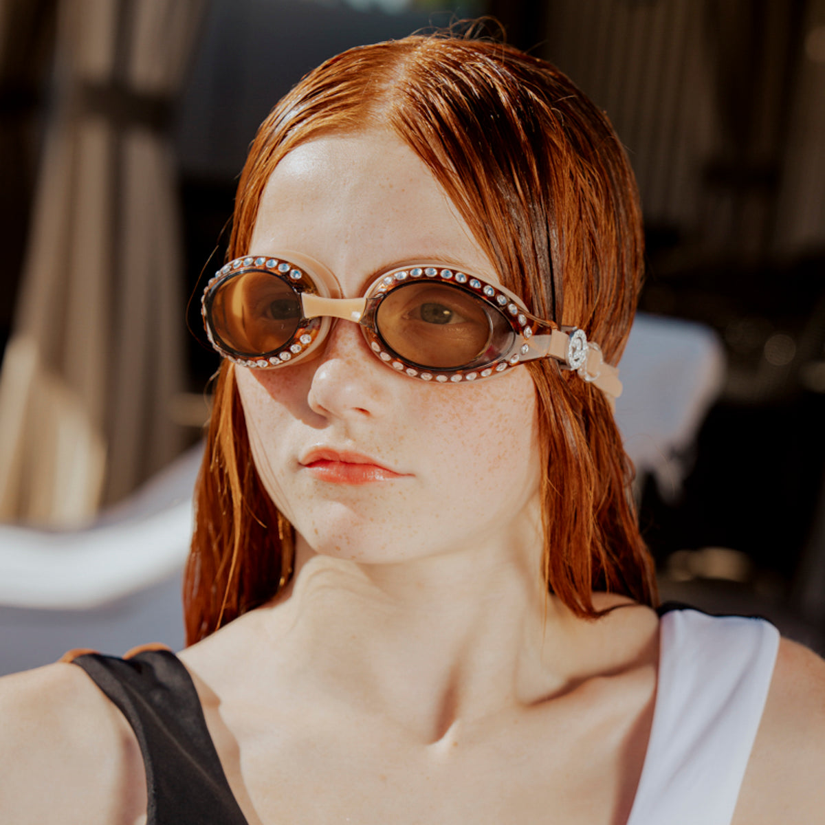 teen girl wearing seek tranquility swim goggles showing tortoise shell frame and rhinestones 