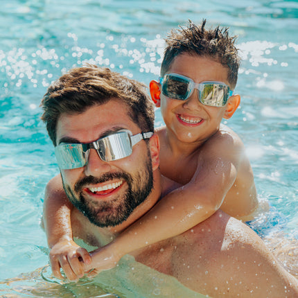 lifestyle image of dad and child both wearing velocity swim goggles 