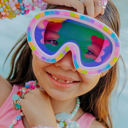 lifestyle image of child in charms, smiling and wearing candy cub swim mask showing 3D gummy bear detail and gummy bear lens