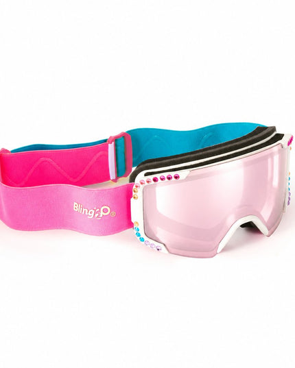 angled product shot of powder pop kids' ski goggles in prism powder showing pink mirrored lens and rainbow rhinestones around white frame with hot pink and blue strap