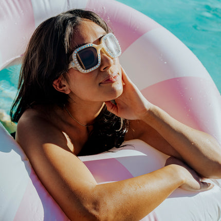 adult women swimming wearing bring vibrancy swim goggles in opal showing wide square framed swim goggles with rhinestones and tinted lens
