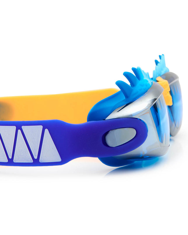close-up view of draco the dragon kids' swim goggles in blue dragon showing a silicone spiked gasket, sharp teeth printed lens and patterned strap